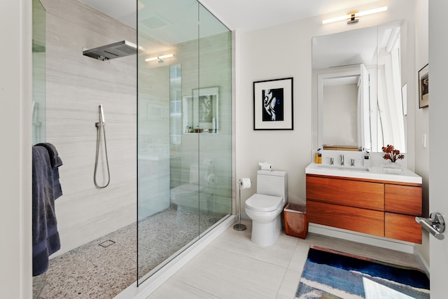 bathroom with tile patterned floors, vanity, an enclosed shower, and toilet