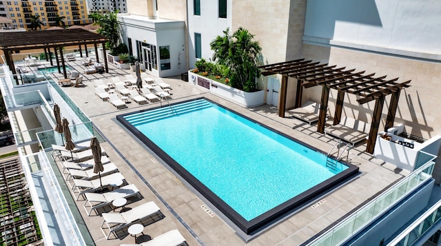 view of pool with a pergola and a patio