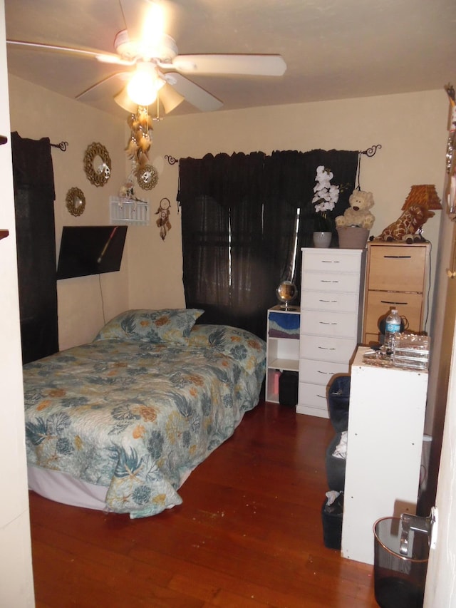 bedroom with ceiling fan and dark hardwood / wood-style floors