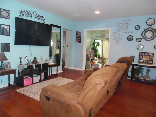 living room with ceiling fan and dark hardwood / wood-style flooring