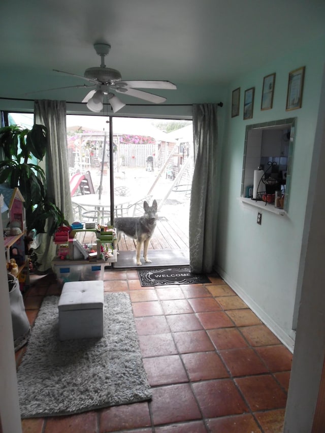 interior space with ceiling fan and tile patterned flooring