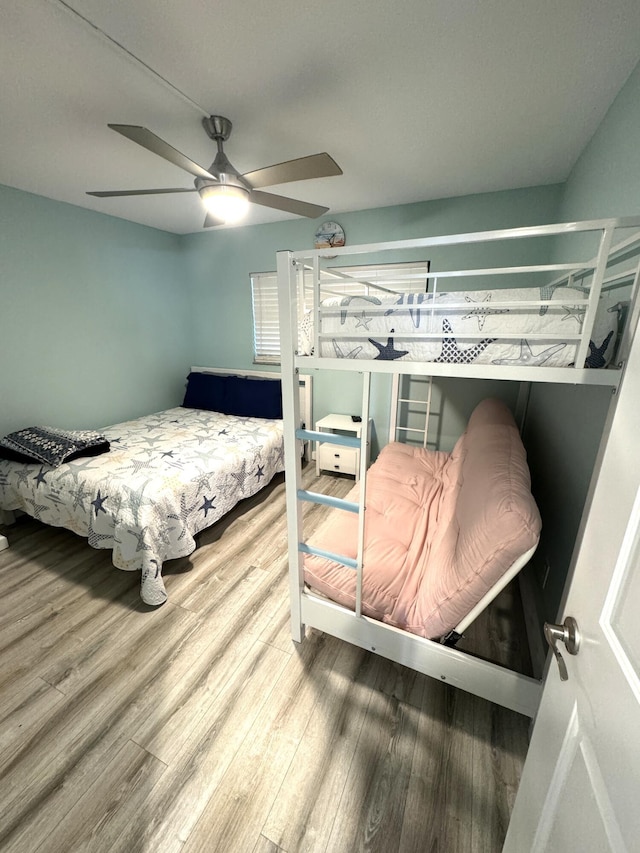 bedroom with hardwood / wood-style flooring and ceiling fan