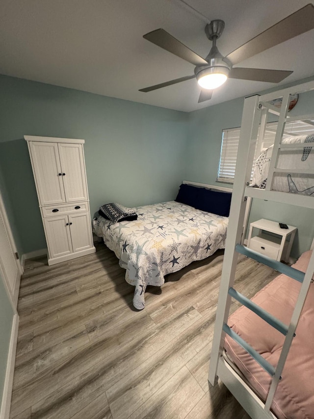 bedroom with ceiling fan and hardwood / wood-style floors