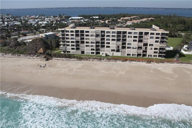 drone / aerial view featuring a water view and a beach view