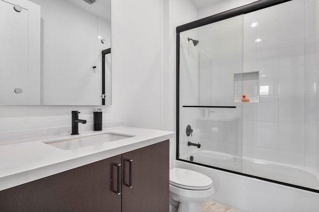 full bathroom featuring tile patterned floors, toilet, vanity, and bath / shower combo with glass door