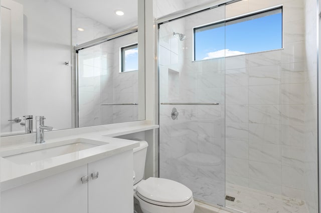 bathroom with an enclosed shower, vanity, and toilet