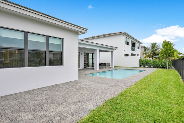 view of pool featuring a patio area and a yard