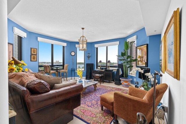 living room featuring a textured ceiling and an inviting chandelier