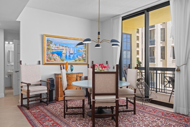 tiled dining space featuring floor to ceiling windows and a textured ceiling