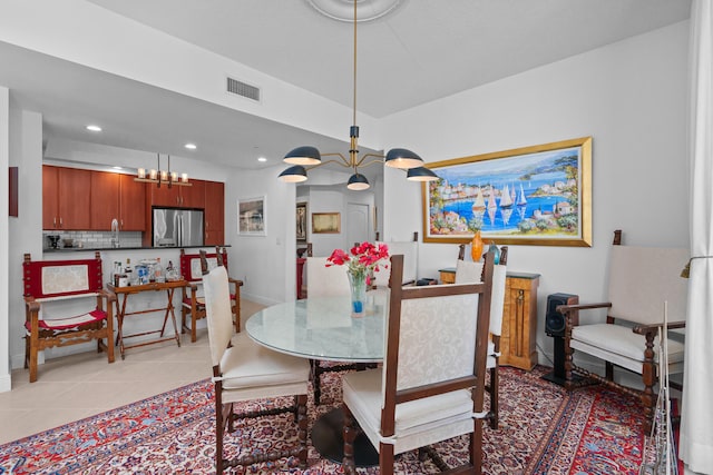 tiled dining room with a notable chandelier