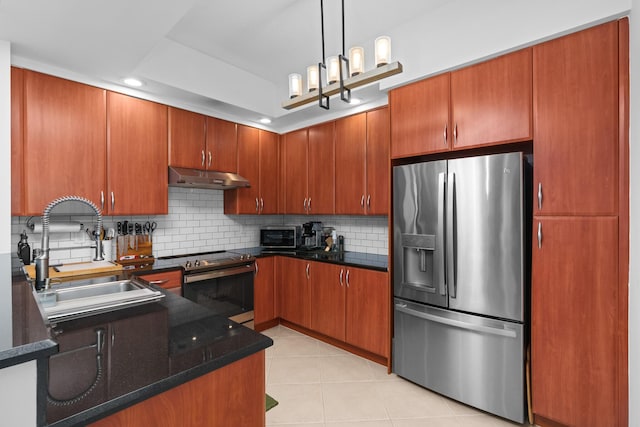 kitchen with light tile patterned floors, tasteful backsplash, stainless steel appliances, under cabinet range hood, and a sink