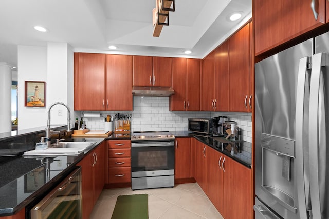 kitchen featuring light tile patterned floors, beverage cooler, stainless steel appliances, under cabinet range hood, and a sink