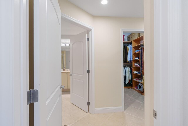 hall with light tile patterned floors