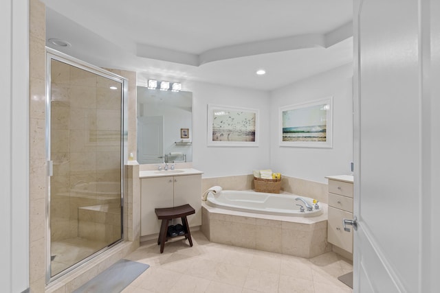 bathroom featuring shower with separate bathtub, vanity, and tile patterned floors