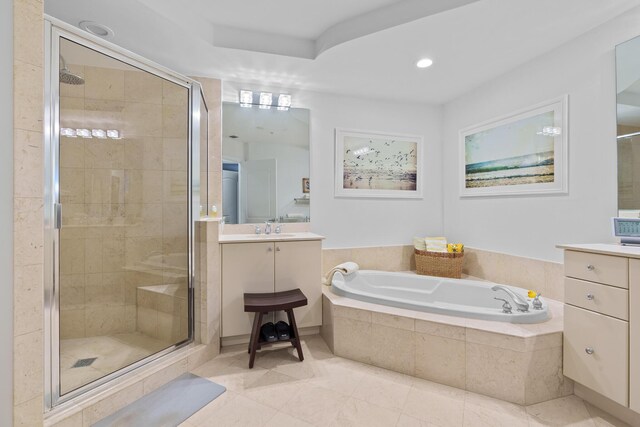 bathroom with plus walk in shower, tile patterned flooring, and vanity