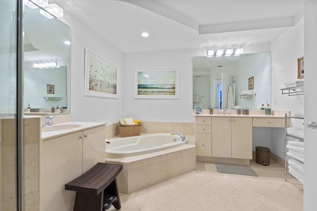 bathroom with a garden tub, two vanities, and a sink