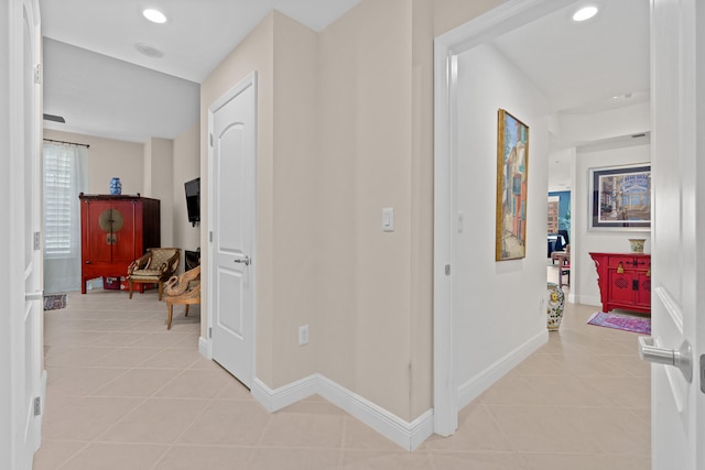 hall featuring light tile patterned floors