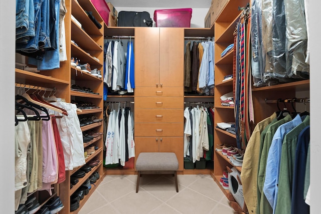 walk in closet with light tile patterned floors