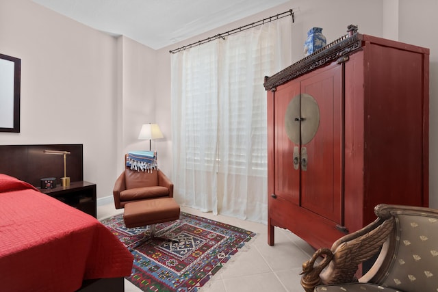 bedroom with light tile patterned floors