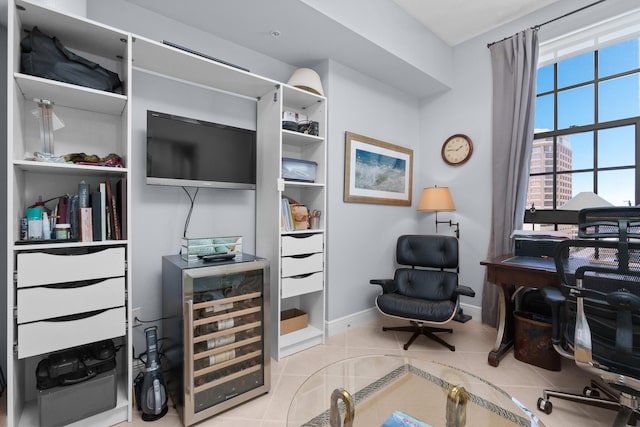 tiled office featuring wine cooler and baseboards