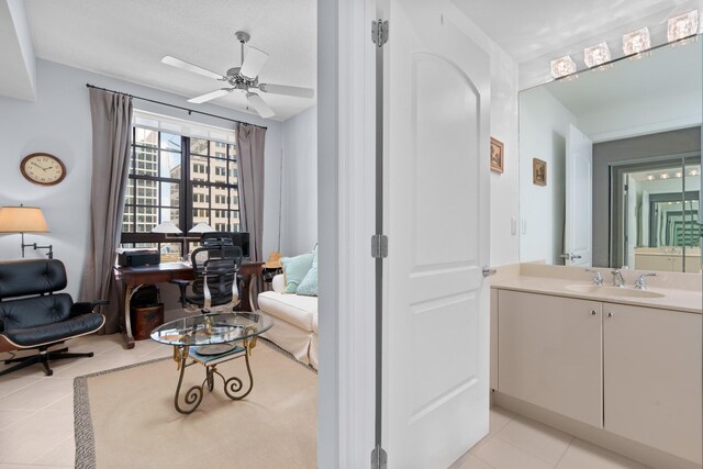 bathroom featuring ceiling fan, tile patterned floors, and vanity