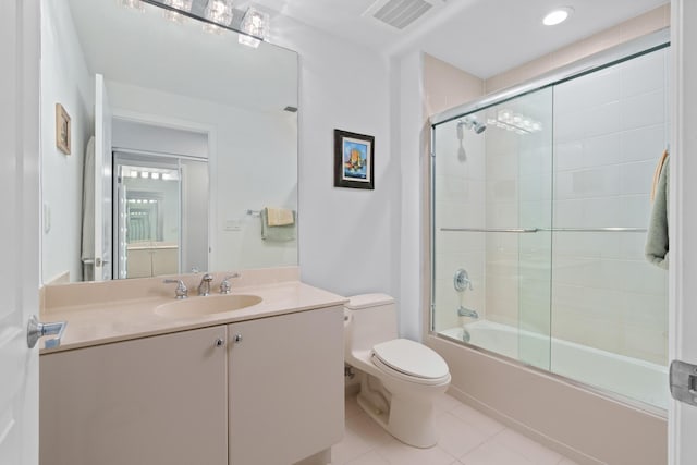 bathroom featuring tile patterned flooring, toilet, vanity, visible vents, and combined bath / shower with glass door