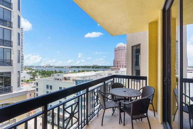 balcony featuring a view of city and a water view