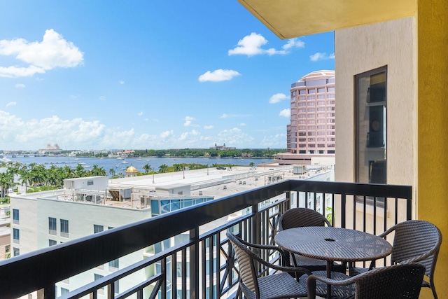 balcony featuring a view of city and a water view