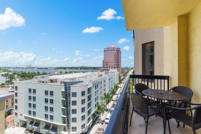 balcony with a water view and a city view