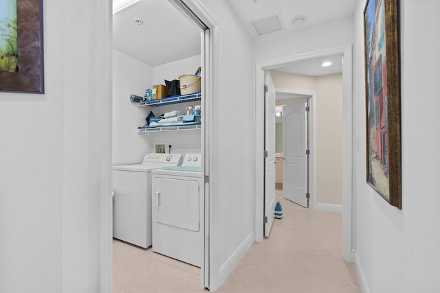 laundry room with light tile patterned floors, laundry area, baseboards, washer and dryer, and attic access