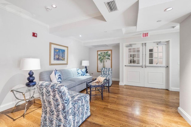 living room featuring hardwood / wood-style floors and crown molding