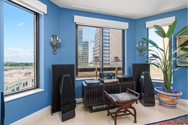 office space featuring plenty of natural light, baseboards, and light tile patterned floors