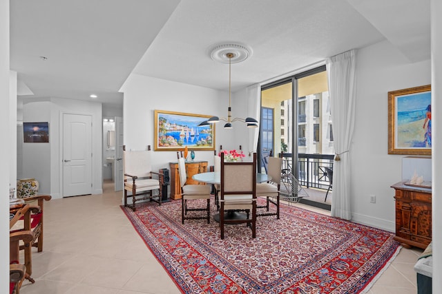 dining space with a wall of windows and light tile patterned floors