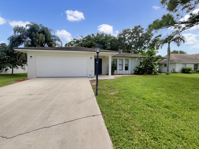 ranch-style house with a front lawn and a garage