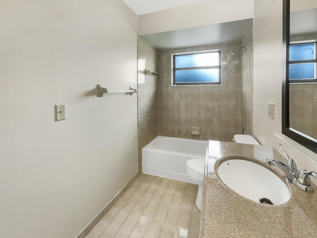 full bathroom with sink, toilet, and tiled shower / bath