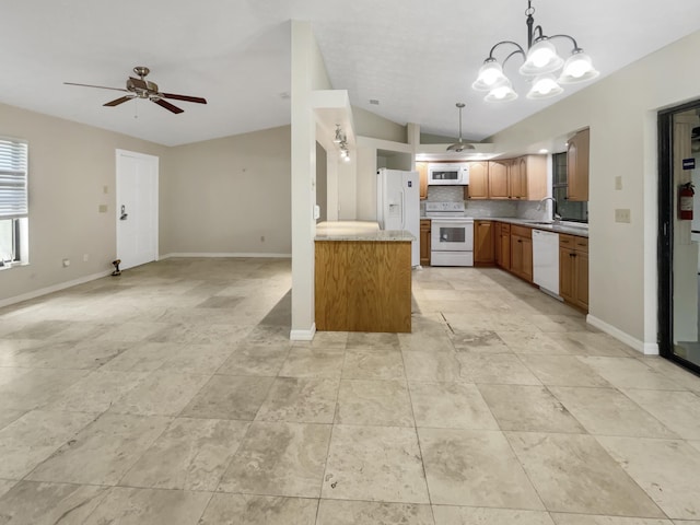 kitchen featuring white appliances, lofted ceiling, pendant lighting, backsplash, and sink