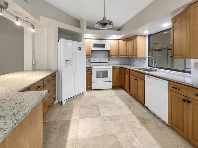 kitchen featuring white appliances, light tile patterned floors, decorative backsplash, light stone countertops, and sink