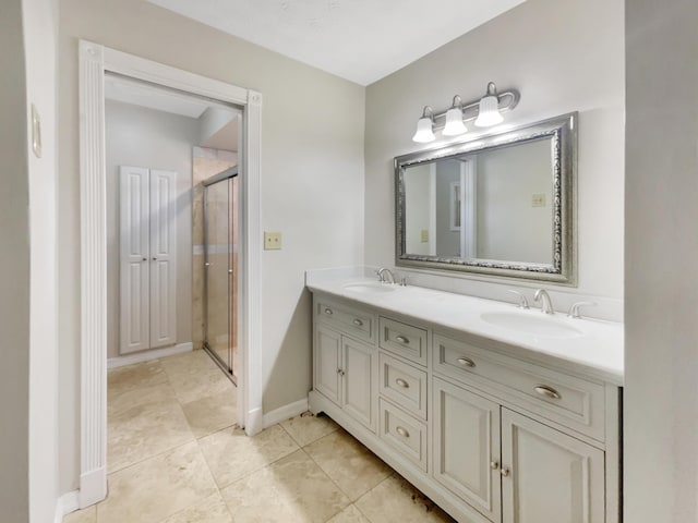 bathroom featuring tile patterned floors, vanity, and a shower with door