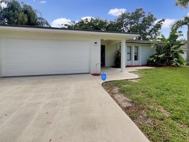 ranch-style home with a front lawn and a garage