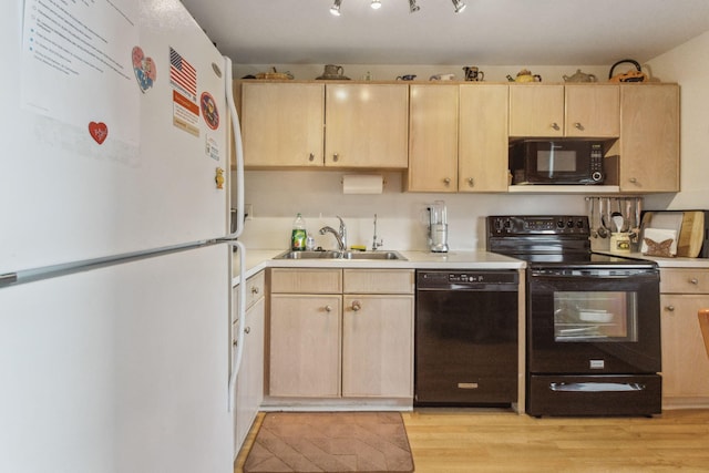 kitchen with sink, black appliances, and light brown cabinets