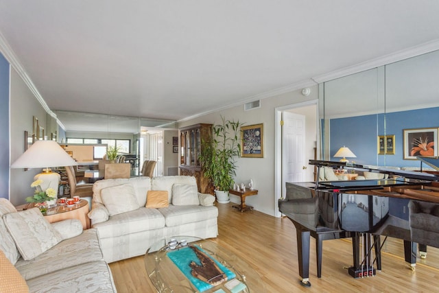 living room with light hardwood / wood-style flooring and crown molding