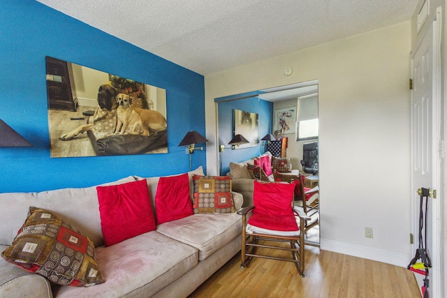 living room featuring a textured ceiling and hardwood / wood-style floors