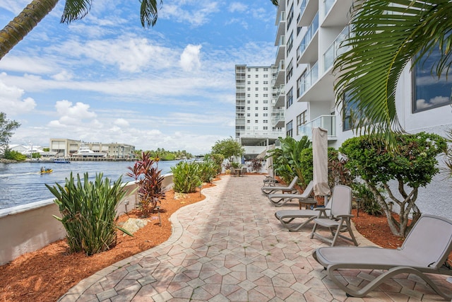 view of patio / terrace with a balcony and a water view