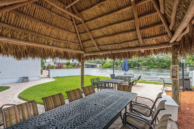 view of patio featuring a gazebo and a water view