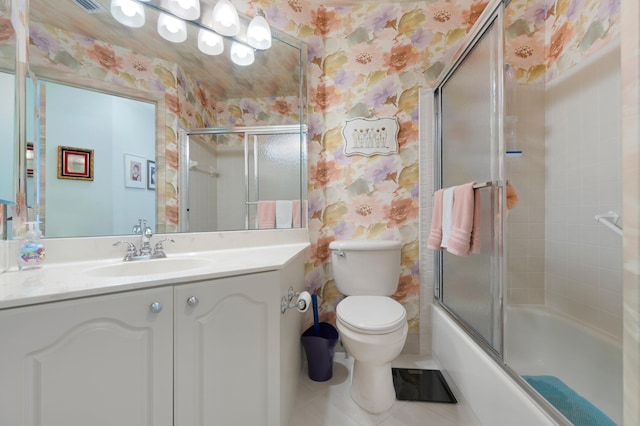 full bathroom featuring tile patterned floors, vanity, combined bath / shower with glass door, and toilet