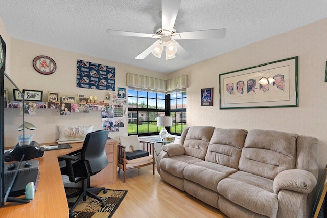 office area with light wood-type flooring, a textured ceiling, and ceiling fan