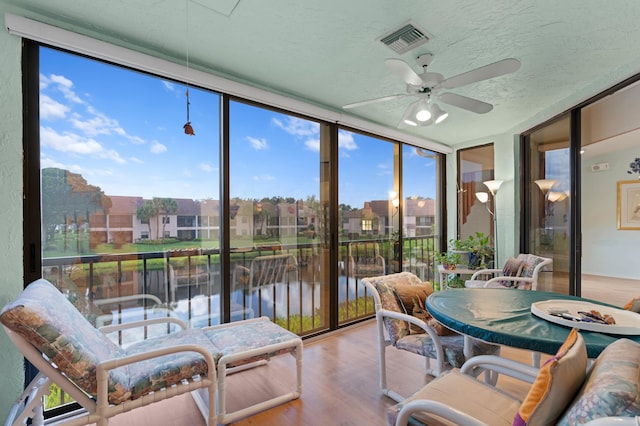 sunroom / solarium featuring ceiling fan