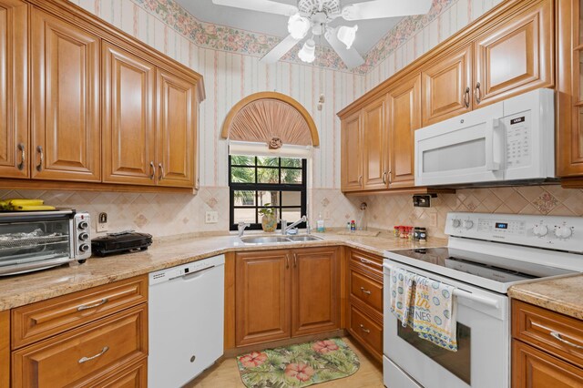 kitchen with ceiling fan, sink, tasteful backsplash, and white appliances