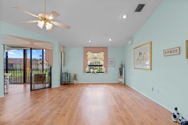 spare room with light wood-type flooring, ceiling fan, and a healthy amount of sunlight