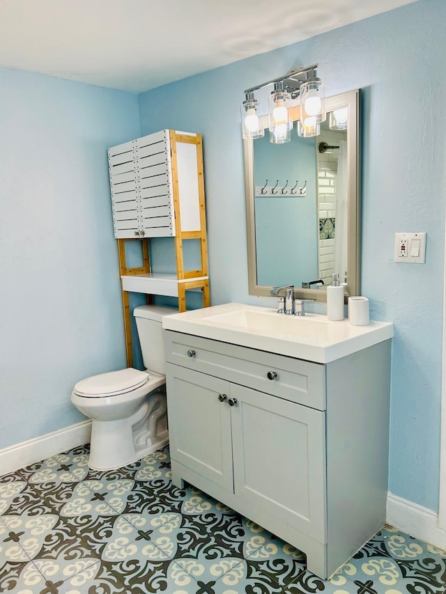 bathroom with tile patterned floors, vanity, and toilet